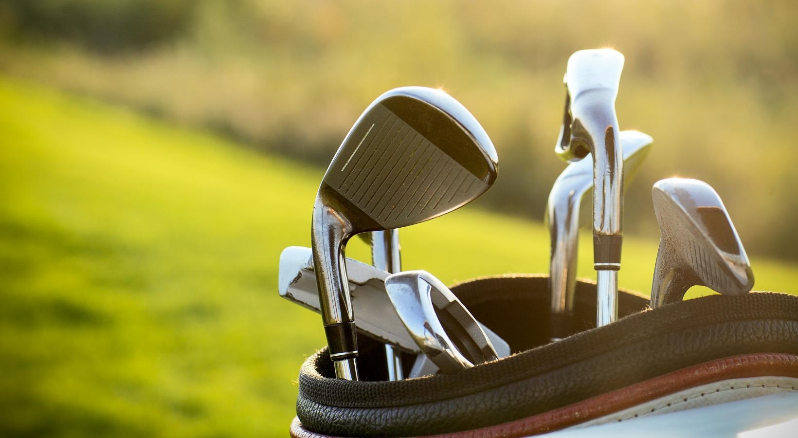 The essence of exceptional living golf clubs in a bag overlooking golf course