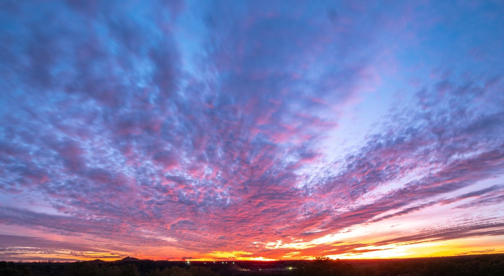Settle into comfort at Yorktown Crossing a colorful sky with clouds
