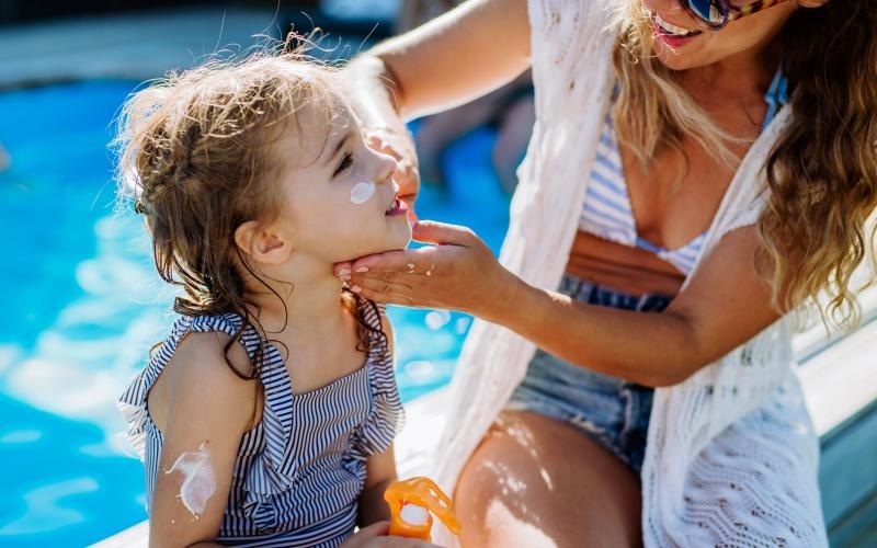 a woman and a child by a pool