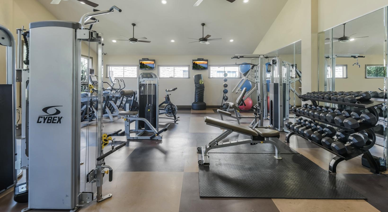 State-of-the-art amenities a gym with exercise equipment
